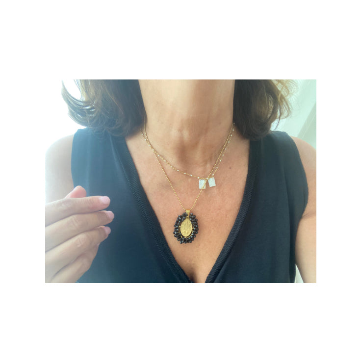 Medalla Milagrosa bordada puesta al cuello junto a un escapulario